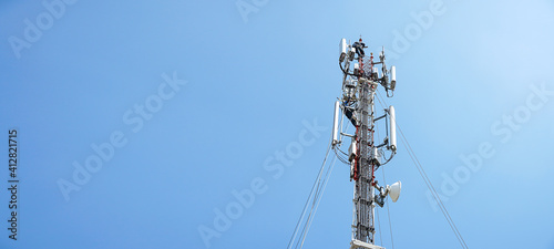 Photographie workers are working at 5g antenna tower for maintaining