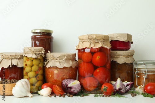 Different pickled food and ingredients on white background