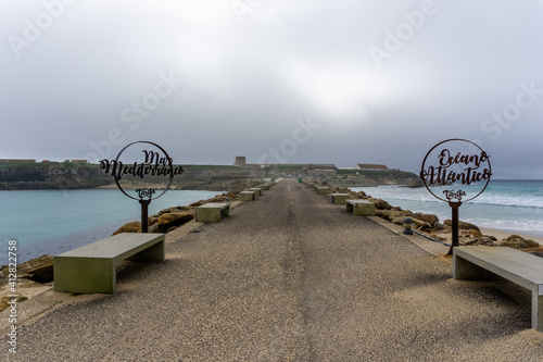 signs on Palomas Island in Tarifa with the Mediterranenan Sea behind photo