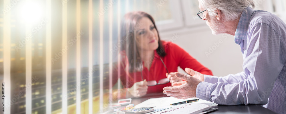 Obraz premium Businesspeople working in office, light effect; multiple exposure