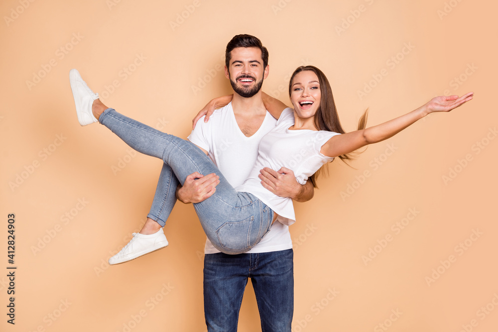 Photo of sweet funny husband wife wear white t-shirts dancing he holding arms her isolated beige color background Stock Photo | Adobe Stock Photo of sweet funny husband wife wear white t-shirts dancing he holding arms her isolated beige color background Stock Photo | Adobe Stock