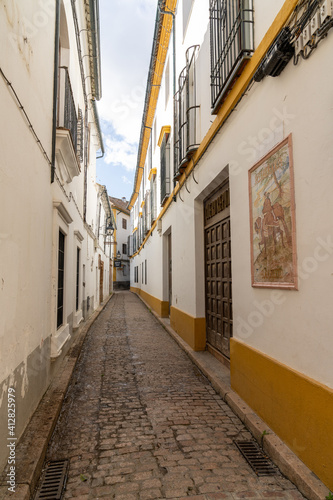 narrow and deserted city street in the old city center of Cordoba © makasana photo