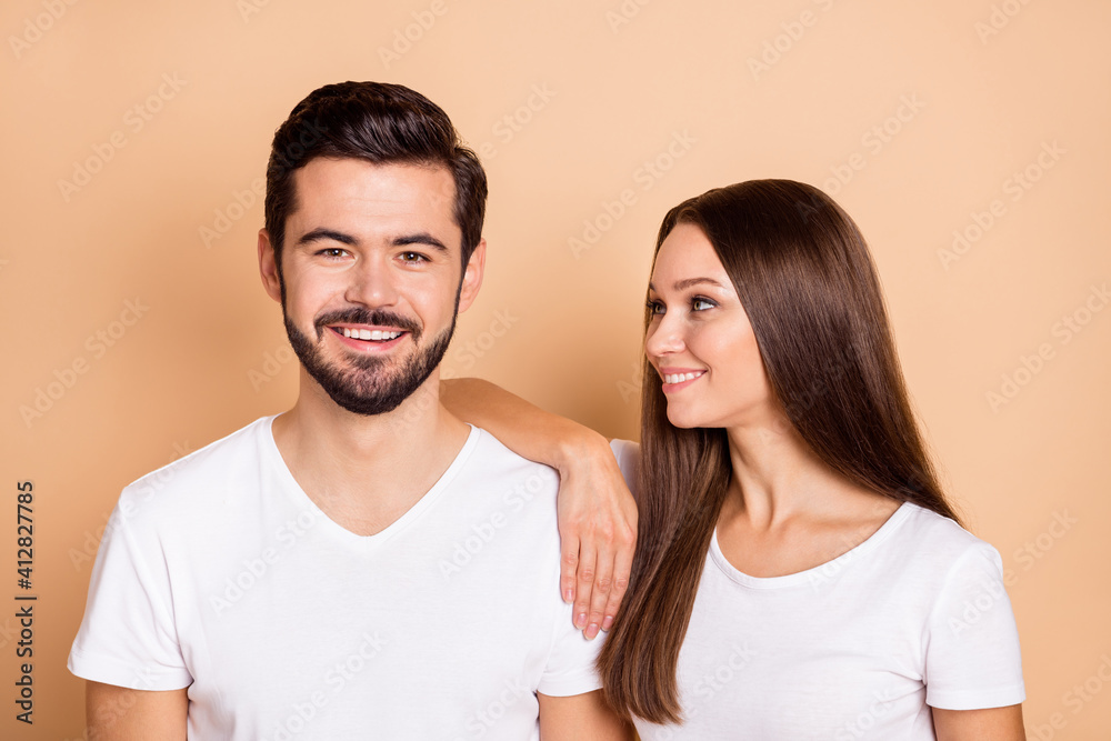 Fototapeta premium Photo of cute adorable husband wife wear white t-shirts smiling arm shoulder isolated beige color background