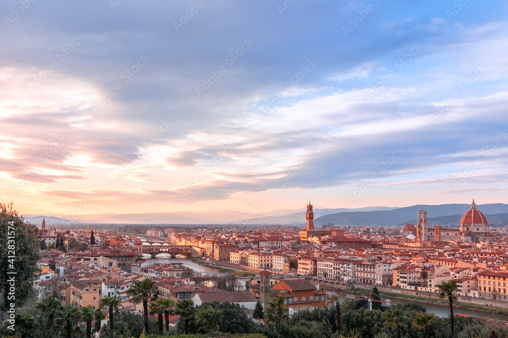 Panoramic view over Florence and its famous landmarks at sunset. Palazzo Vecchio, Florence Cathedral, Ponte Vecchio. Tuscany, Italy