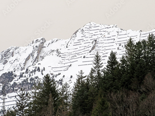 Snowy alpine mountain massif Mattstogg during winter in the Swiss Alps and over the Lake Walen or Lake Walenstadt (Walensee), Amden - Canton of St. Gallen, Switzerland (Schweiz) photo