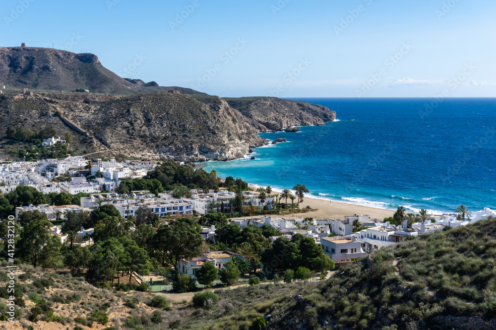 view of the idyllic whitewashed fishing village of Agua Amarga on the coast of Andalusia