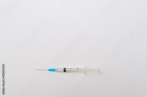 Medical plastic syringe for injection and vaccination on paper background