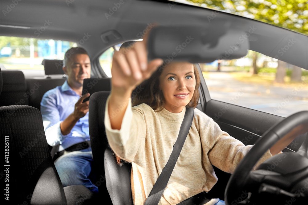 transportation, vehicle and people concept - happy smiling female driver driving car with male passenger using tablet pc computer