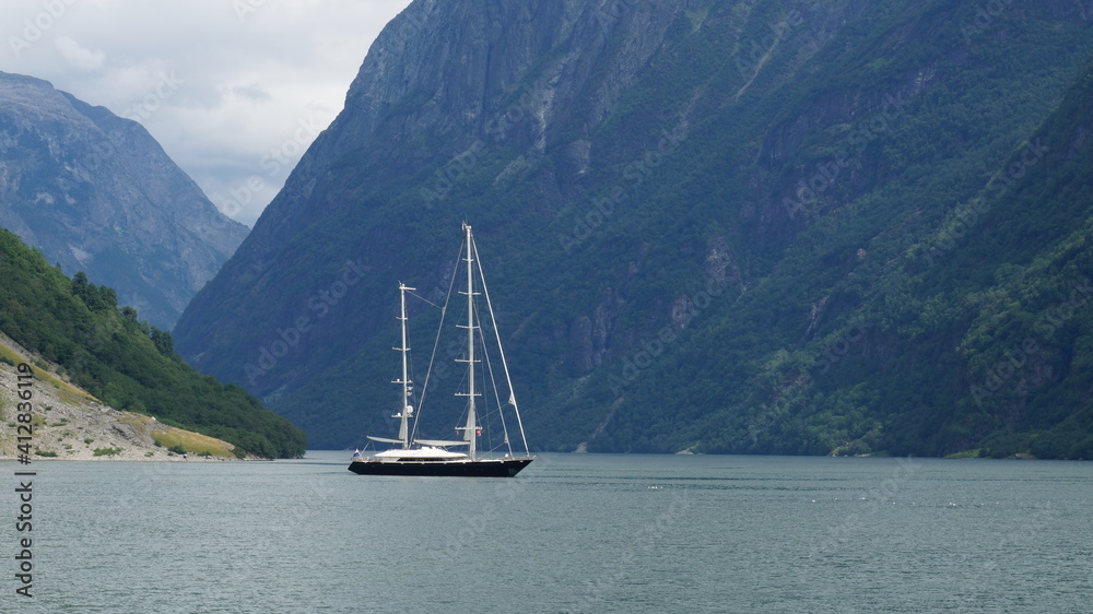 Naklejka premium sailing boat on the fjord