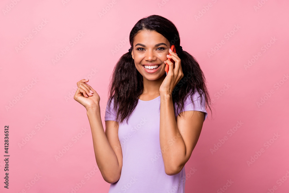 Photo of lovely dark skin brunette pigtails hair woman hold talk phone happy isolated on pastel pink color background Photo of lovely dark skin brunette pigtails hair woman hold talk phone happy isolated on pastel pink color background