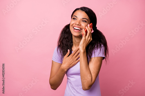 Portrait of pretty cheerful girl talking on phone discussing news cellular isolated over pink pastel color background