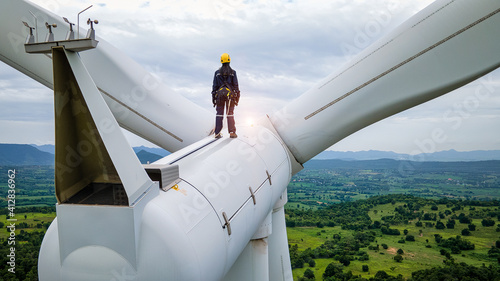  Female Inspection engineers standing on top of a wind turbine and looking beautiful  landscape
 photo