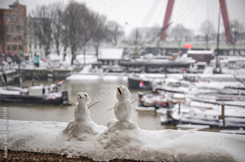 Two tiny snowmen built after the first serious snowfall in years near the Old Harbour in Rotterdam  The Netherlands