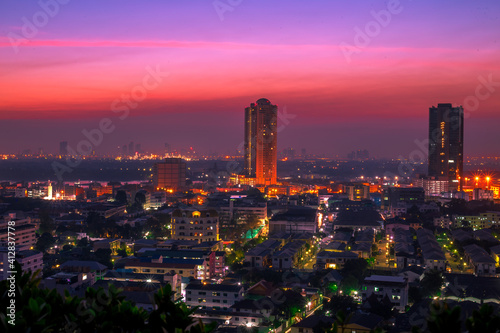 The high angle background of the city view with the secret light of the evening  blurring of night lights  showing the distribution of condominiums  dense homes in the capital community