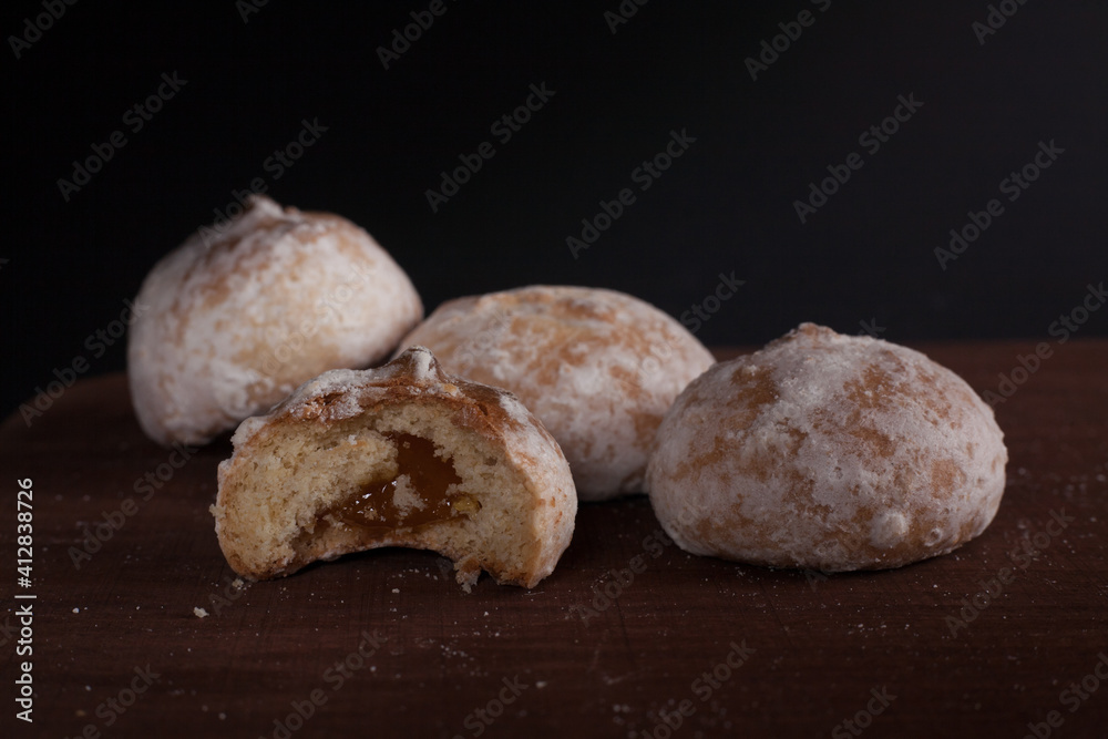 Fresh Russian gingerbread cookies on a wooden stand. On a dark background. Fresh Russian gingerbread cookies on a wooden stand. On a dark background.