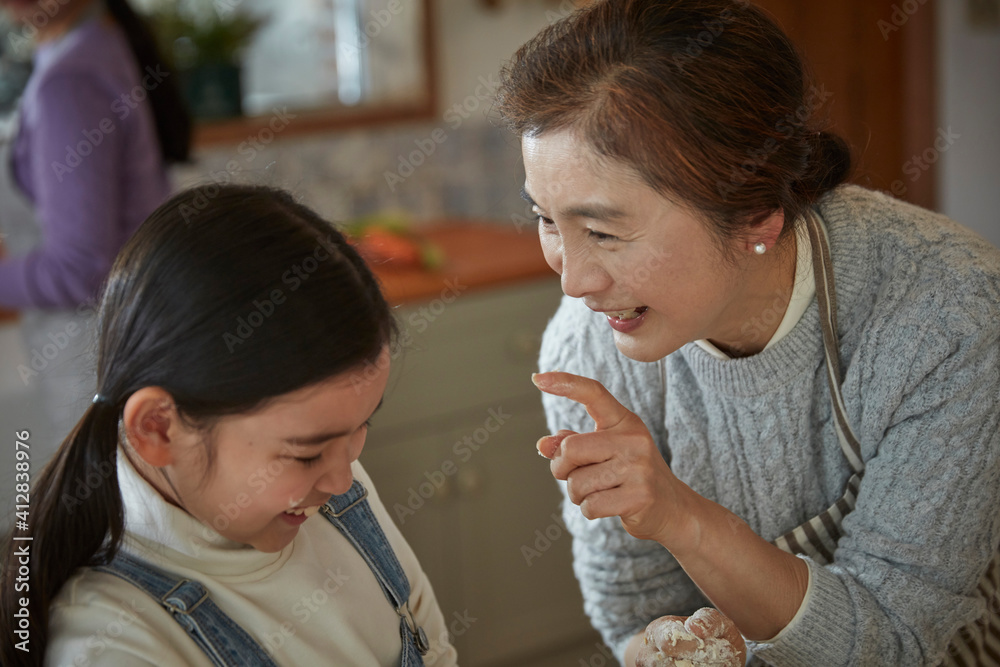 Happy adorable little child girl in apron enjoying cooking homemade pastry together with family at home. Happy adorable little child girl in apron enjoying cooking homemade pastry together with family at home.