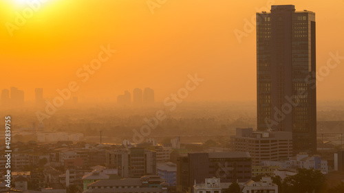 The blurred abstract background of the morning sun exposure to the tiny dust particles that surround the tall buildings in the capital  the long-term health issue of pollution