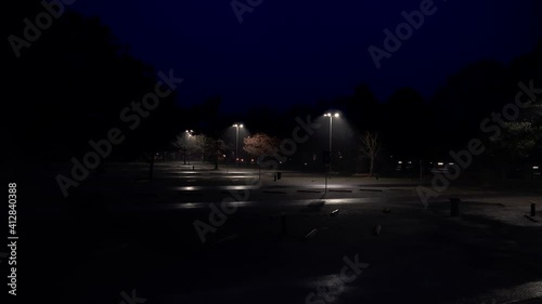 Empty parking lot with street lights at night