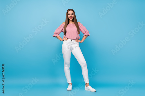 Full length body size view of attractive content cheerful cheery straight-haired girl posing isolated over bright blue color background