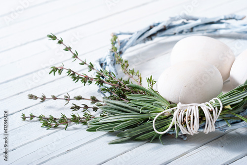 Photography easter wreath with white wooden eggs on bright table