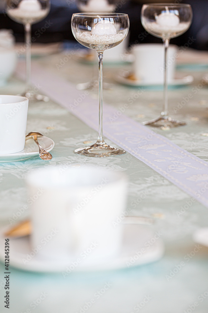 Obraz premium Winter cosiness, coffee in a white cup and sweeties on a light background. High quality photo
