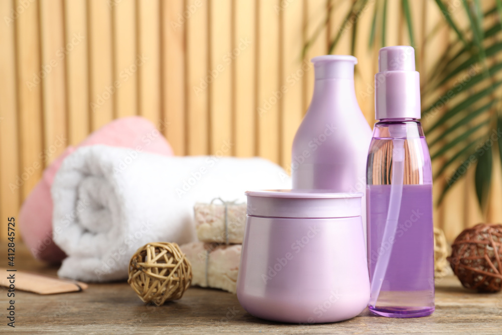 Set of hair care cosmetic products on wooden table Set of hair care cosmetic products on wooden table
