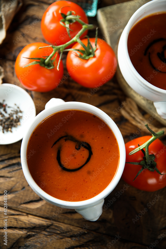 Homemade spicy tomato soup in a white bowl Homemade spicy tomato soup in a white bowl