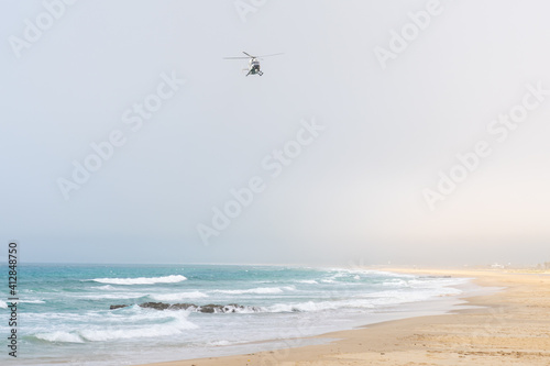 a Guardia Civil Spanish police helicopter flying over the Strait of Gibraltar