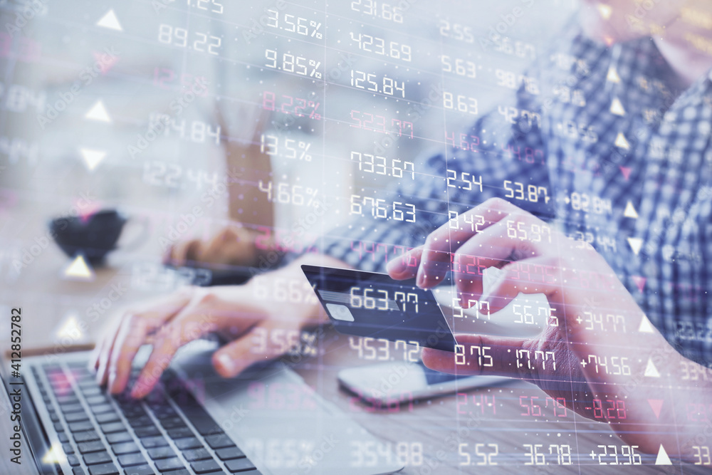 Double exposure of man hands holding a credit card and Forex graph drawing. Stock trading and digital fintech in Internet E-commerce concept. Double exposure of man hands holding a credit card and Forex graph drawing. Stock trading and digital fintech in Internet E-commerce concept.