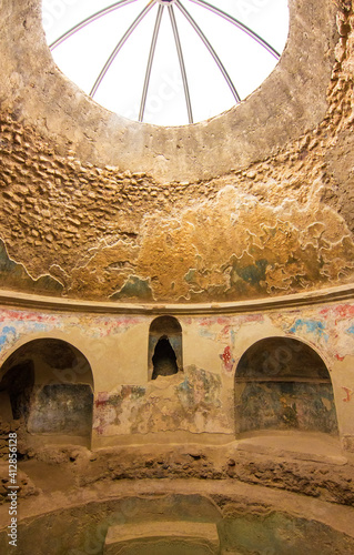 Interior of the bathroom in Stabian Baths at ancient Roman city of Pompei, buried under ashes after eruption of Vesuvius. Ancient frigidarium or cold baths, Campania, Italy. UNESCO World Heritage Site