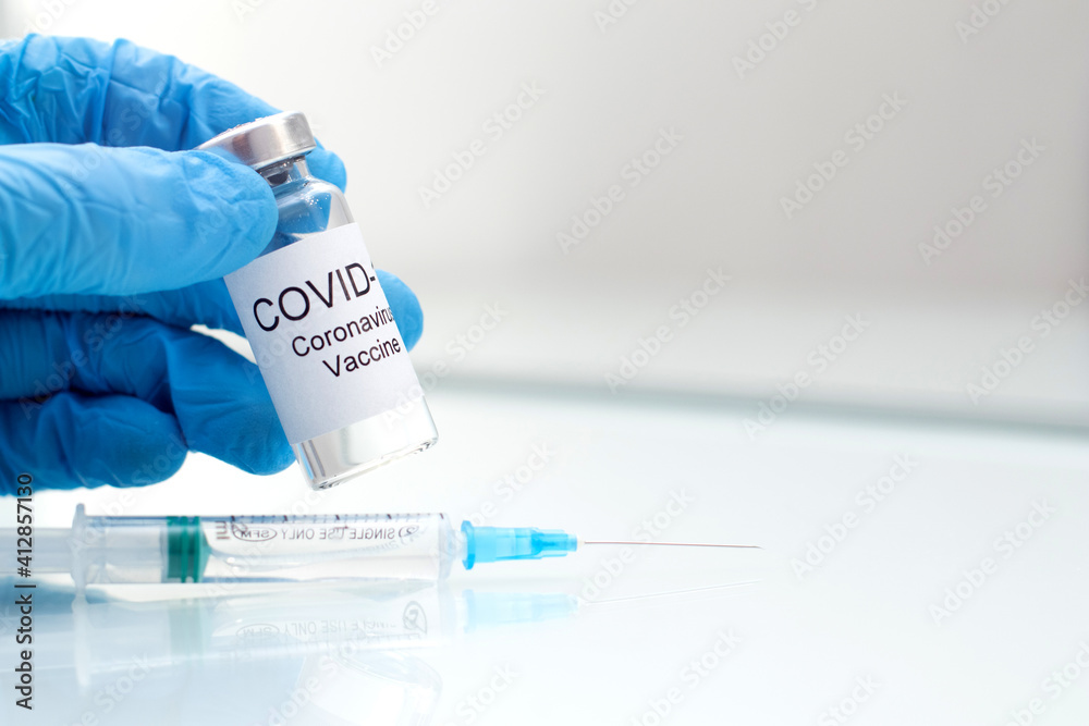 Medical doctor holding and filling tube with Coronavirus vaccine for 2019-nCoV virus. Novel Coronavirus 2019-nCoV. Medical doctor holding and filling tube with Coronavirus vaccine for 2019-nCoV virus. Novel Coronavirus 2019-nCoV.