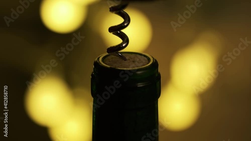 Opening Wine Bottle with Corckscrew. Romantic Atmosphere for Dinner at Restaurant. Bokeh Background and Low Key Lighting. Macro Shot. B Roll.