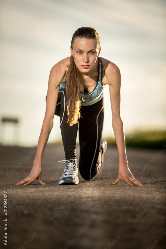 Fototapeta premium Young woman running , preparing for the run. 