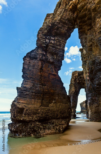 Natural rock arches on Cathedrals beach in low tide (Cantabric coast, Lugo (Galicia), Spain).