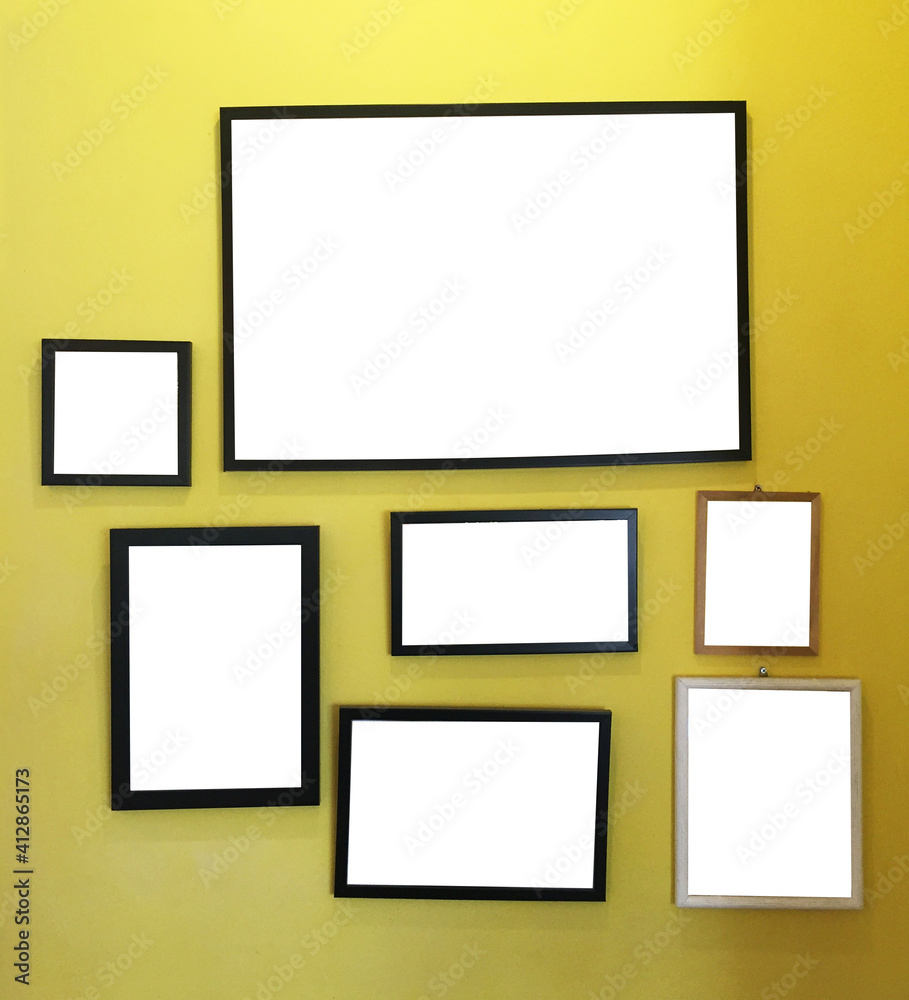 Collection of blank picture frame on yellow wall Collection of blank picture frame on yellow wall