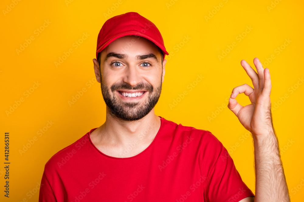 Close-up portrait of nice cheerful guy skilled content mailman showing ok-sign ad isolated over bright yellow color background Close-up portrait of nice cheerful guy skilled content mailman showing ok-sign ad isolated over bright yellow color background
