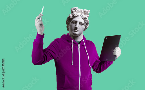 Modern art collage. Concept portrait man holding tablet and pencil. Gypsum head of Apollo.