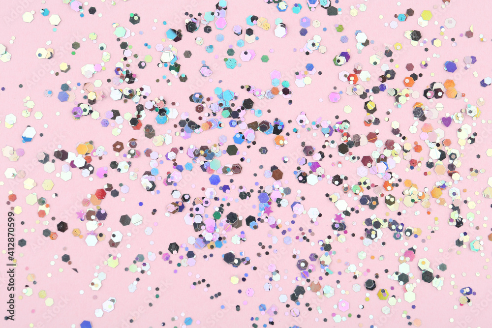 Shiny glitter on light pink background, top view Shiny glitter on light pink background, top view