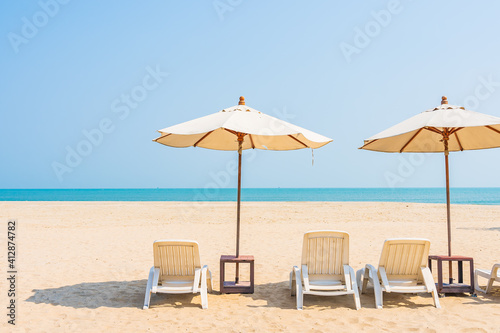 Umbrella and chair around beach sea ocean on blue sky © siraphol