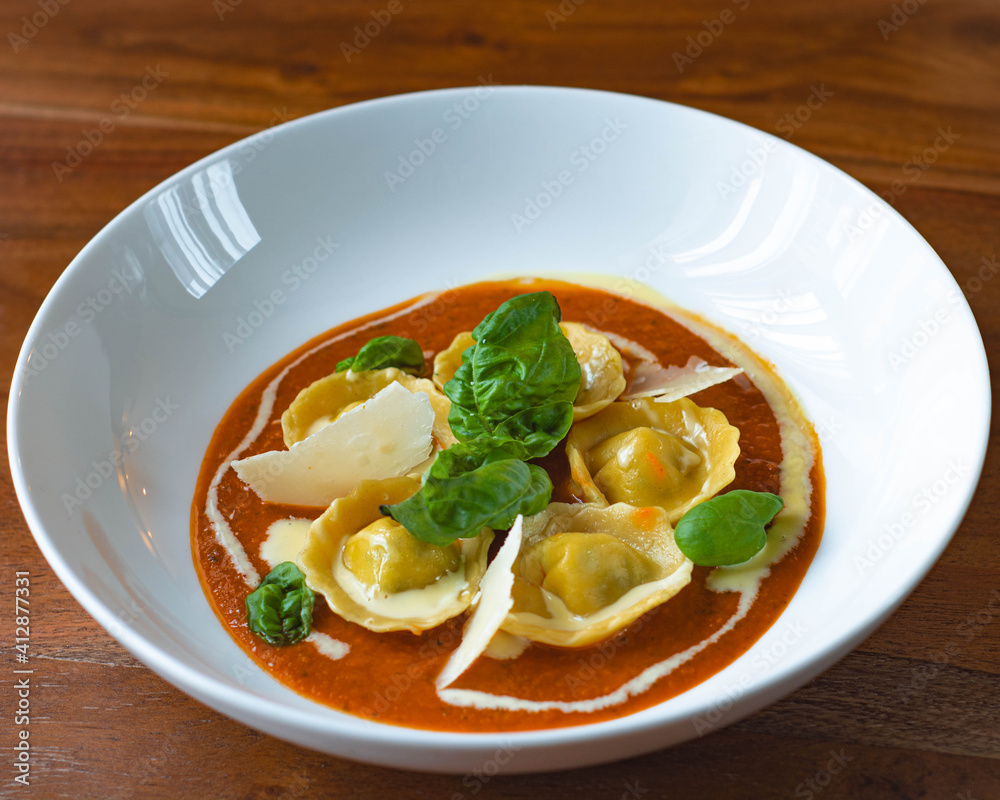 Handmade Tortelli with tomato sauce , basil and parmesan shavings. Revisited dish of Melanzane alla Parmigiana ( eggplant parmigiana) Handmade Tortelli with tomato sauce , basil and parmesan shavings. Revisited dish of Melanzane alla Parmigiana ( eggplant parmigiana)