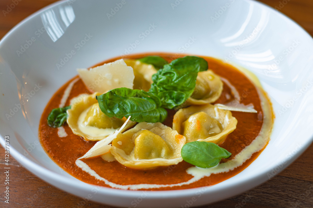 Handmade Tortelli with tomato sauce , basil and parmesan shavings. Revisited dish of Melanzane alla Parmigiana ( eggplant parmigiana)