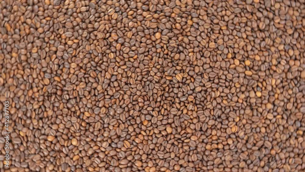 Roasted coffee beans. Coffee grains view from the top. Seamless loop footage. Roasted coffee beans. Coffee grains view from the top. Seamless loop footage.