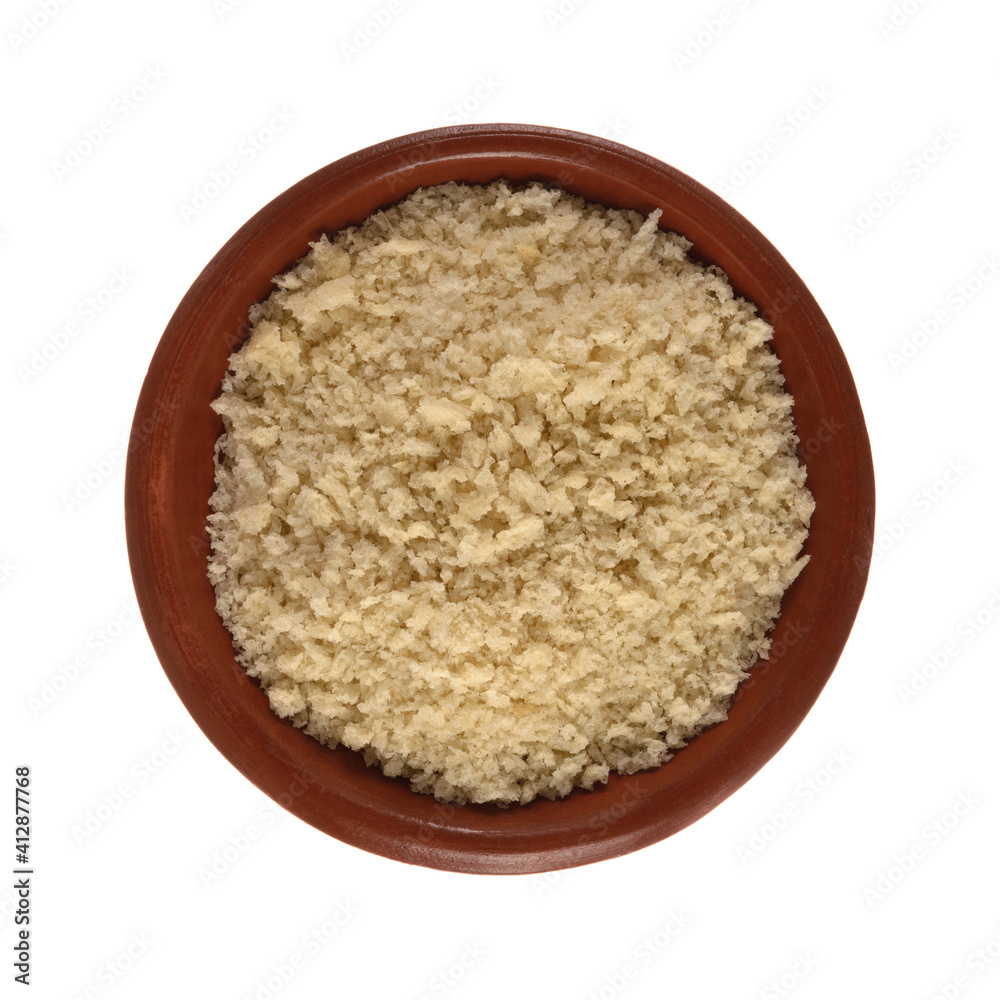 Small terracotta bowl filled with white bread crumbs isolated on a white background top view. Small terracotta bowl filled with white bread crumbs isolated on a white background top view.