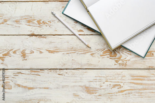 Blank open books and pencil...