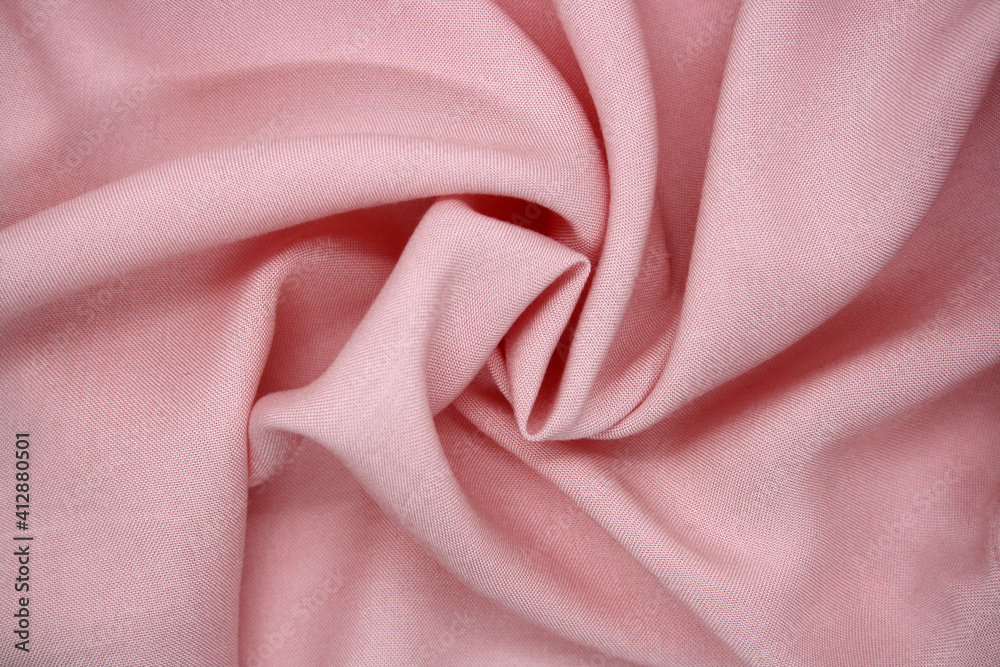 Fototapeta premium The background is made of synthetic fabric lying in waves.