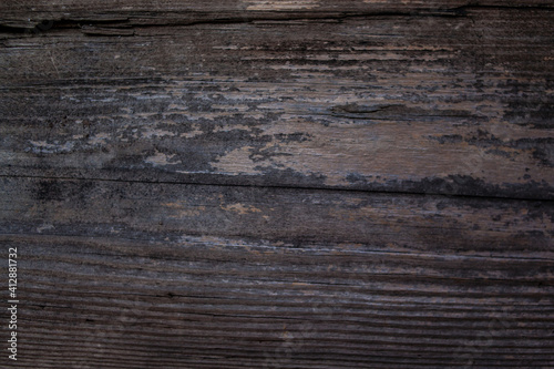 weathered dark wood background with texture. Texture of brown and grey old wood. Wide burned board texture close-up. a wooden surface.