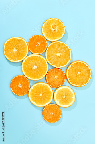 ripe slice orange fruit on blue background. top view