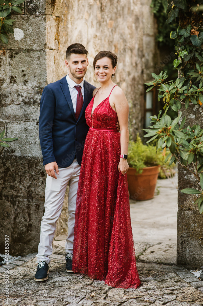 Elegant young couple on a luxurious building with vegetation Elegant young couple on a luxurious building with vegetation