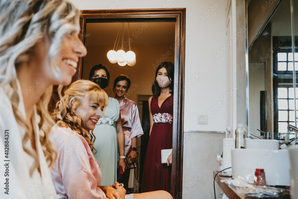 Group of bridesmaids with surgical masks before the wedding Group of bridesmaids with surgical masks before the wedding