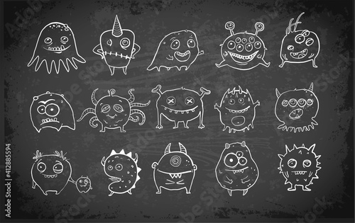 Cute Doodle monsters on blackboard background.  Microbe and bacteria doodles. 